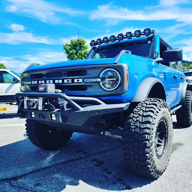 Blue Ford Bronco with Dirt Logic Complete Lift Suspension from Fabtech Motorsports, 
Bumpers and Spare Tire Delete by Fab Fours Bumpers, Sitting on 37x12.50R17 Mickey Thompson Performance Tires and Wheels Baja Bosses, 312 Method Race Wheels, Bestop Skyrider Top, and Baja Designs Lighting