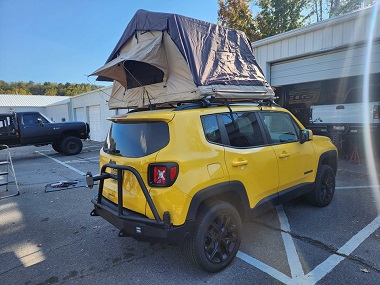 Yellow Jeep Renegade with 1.5 inch TeraFlex Suspensions Lift, MOVE Bumpers, Rear Bumper, Appalachian 4x4 Rear Swing Out Carrier, Outland Motorworks Nearabout Roof Top Tent, Rough Country Rear Lights, and LED Conversion